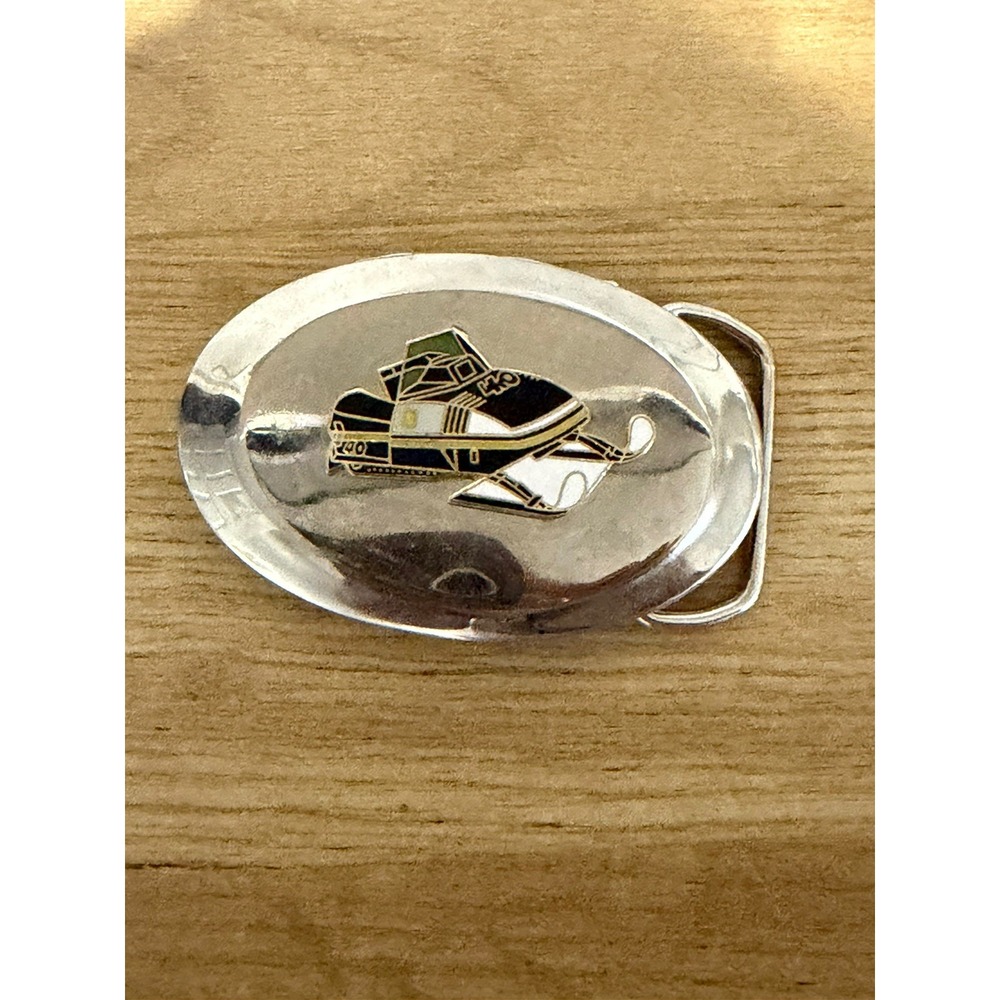Vintage Enameled Oval Belt Buckle Featuring a Classic Snowmobile